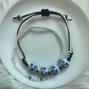 One porcelain vibes white/blue/black adjustable bracelet  +one bead bracelet